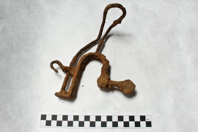 Rusted metal mounting item, hook attached and bent